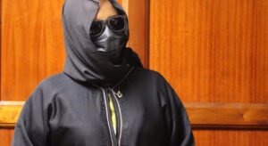 Mwikali hiding her face when she appeared in court.