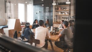 Business professionals gathered around conference desk discussing proposal automation