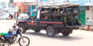 Police officers patrol the streets of Kakamega in a landcruiser to disperse supporters of Democracy for the Citizens Party on May 24, 2025.