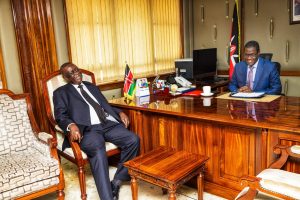 Energy CS Opiyo Wandayi and Siaya Senator Oburu Odinga having a light moment when the latter visited him in his office.