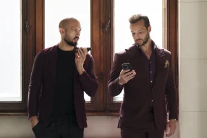 Andrew Tate, left, and his brother Tristan, right, wait at the Court of Appeals building in Bucharest, Romania, on Oct. 15, 2024. (AP Photo/Vadim Ghirda, File)