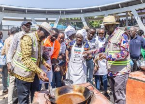Ruto and Raila trying their Havis at frying fish during official inauguration of modern fish market in Homa Bay.