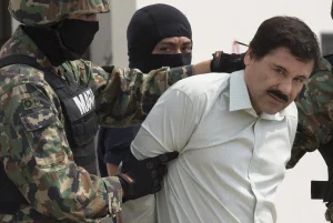 Joaquin “El Chapo” Guzman is escorted to a helicopter by Mexican security forces at Mexico’s International Airport in Mexico City on Feb. 22, 2014. Photographer: Susana Gonzalez/Bloomberg