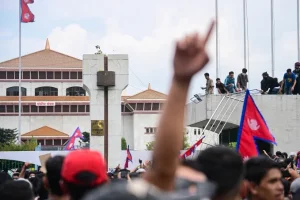 Gen Z protesters gather on the roof and in front of the parliament house as clashes erupt with police at the Federal Parliament in Kathmandu, Nepal, on September 8, 2025. Prakash Shrestha/NurPhoto/Getty Images