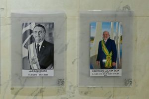 Portraits of former Brazilian president Jair Bolsonaro and current President Luis Ignacio Lula da Silva in the presidential palace in Brasilia / AFP