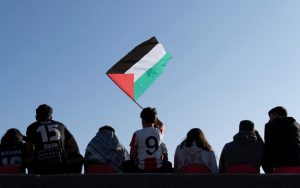 A Club Palestino fan waves a Palestinian flag during a local league soccer match against Santiago Wanderers at La Cisterna stadium in Santiago, Chile, Friday, July 12, 2024. (AP Photo/Matias Basualdo)