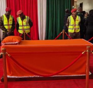 An orange-draped bed, which had been prepared in Parliament