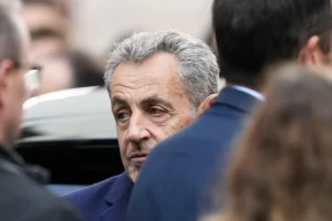 Former French President Nicolas Sarkozy reacts before entering a police car Tuesday, Oct. 21, 2025 in Paris as he heads to prison to serve time for a criminal conspiracy to finance his 2007 election campaign with funds from Libya. (AP Photo/Thibault Camus)
