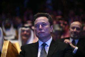 Billionaire Elon Musk looks on as President Donald Trump speaks at the U.S.-Saudi Investment Forum at the John F. Kennedy Center for the Performing Arts in Washington, D.C. on Nov. 19, 2025. The Trump administration told Reuters on Nov. 23, 2025 that it has disbanded the Department of Government Efficiency (DOGE), which was initially led by Musk before the Tesla founder publicly feuded with the president.Brendan Smialowsky/AFP via Getty Images