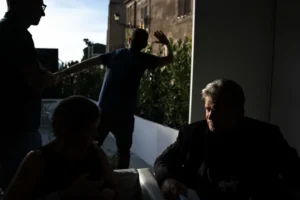 Former White House Chief Strategist Steve Bannon talks with Giorgia Meloni, leader of the Brothers of Italy, before speaking at Atreju 2018, a conference of right wing activists, as aids block cameras from viewing through the bushes behind on September 22, 2018 in Rome, Italy. Meloni, known for her conservative ideals, is now prime minister of Italy. Jabin Botsford/The Washington Post/Getty Images
