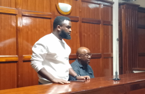 Jonathan Ngenga (Standing) and Peter Kamau appear before Milimani Chief Magistrate Lucas Onyina on Friday, February 20, 2026. 