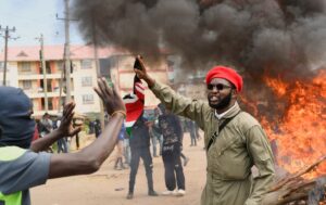 A demonstrator gestures as they erect a barricade during a protest against a U.S.-backed Ebola quarantine plan and the establishment of a 50-bed facility at a Kenyan air force base that was intended to host Americans exposed to Ebola, in Nanyuki town, in Laikipia County, Kenya, June 1. REUTERS